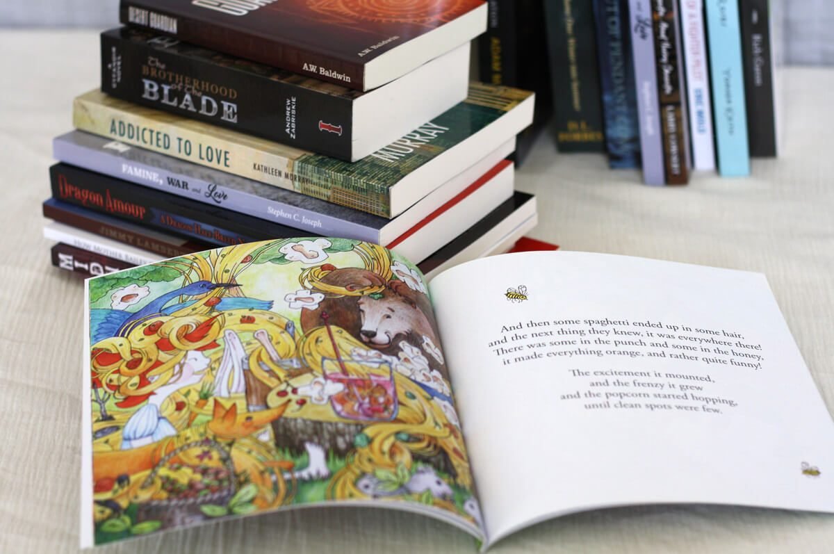 Printed paperback books and an open full-color picture book showing how format and interior affect printing costs