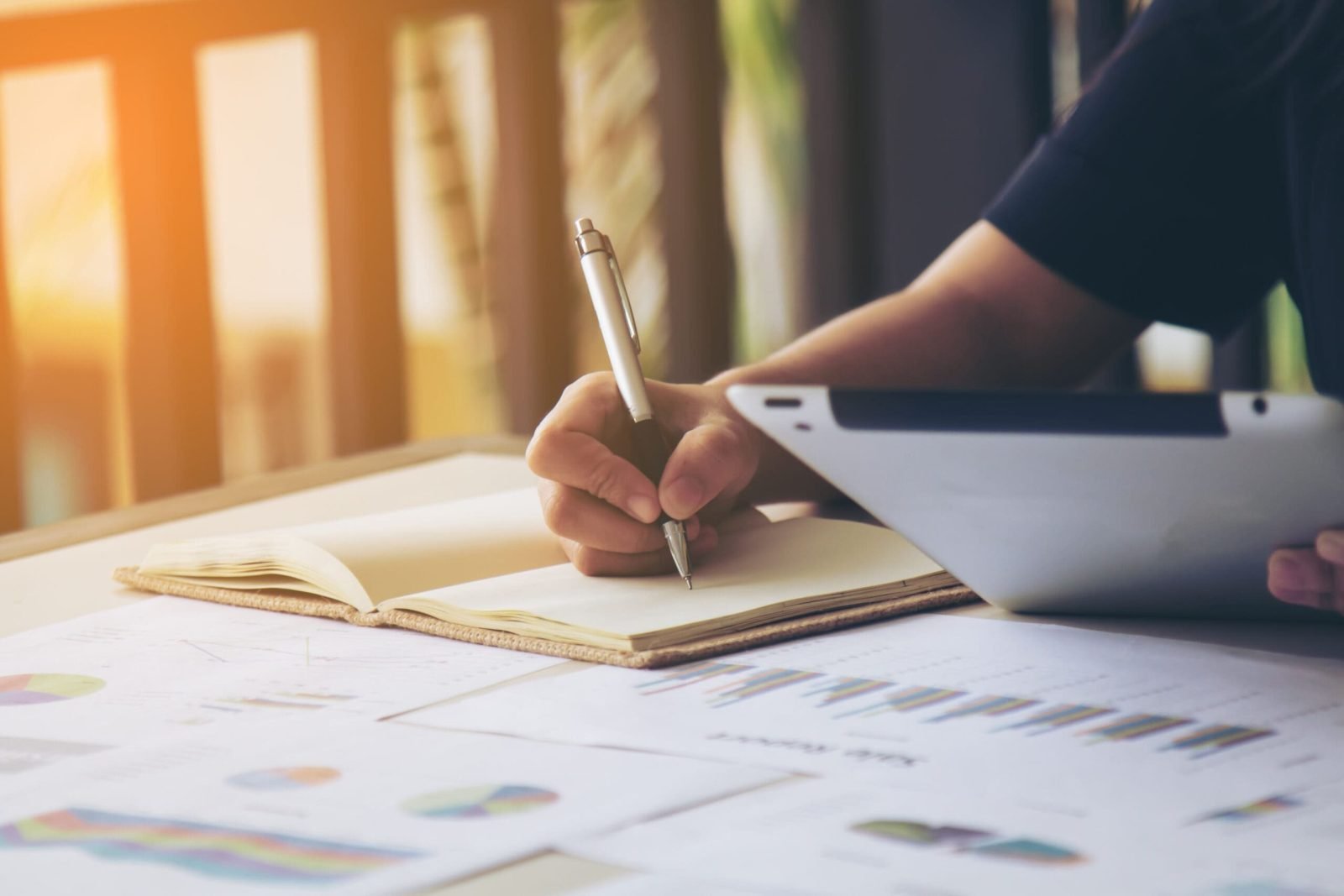 Author planning a book publishing budget with notes and cost charts