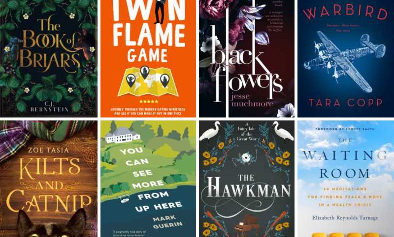 A collection of the year's best books displayed on a wooden table, showcasing diverse genres and vibrant covers